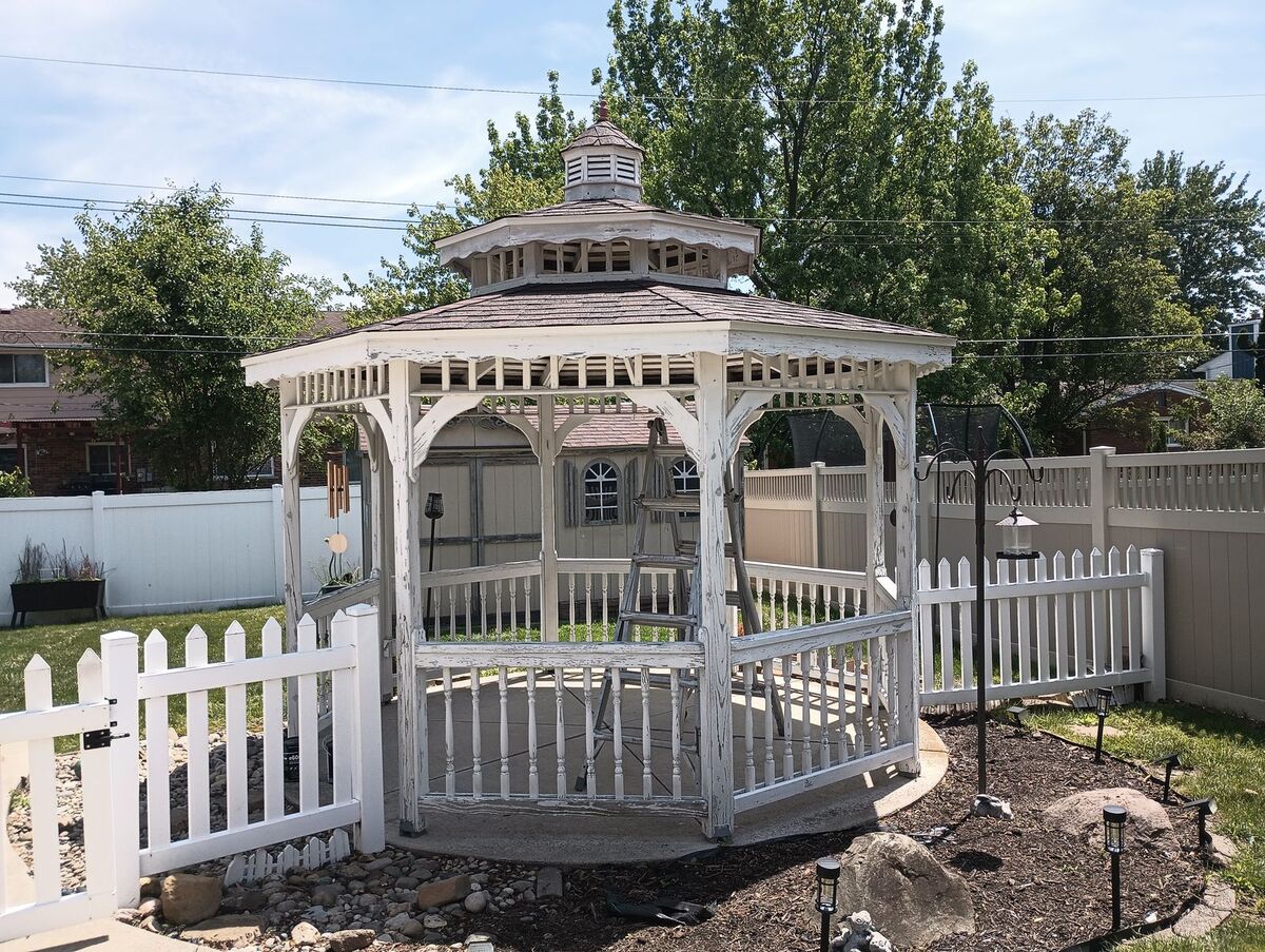 Same gazebo before repaint, heavily peeling old white paint, side angle