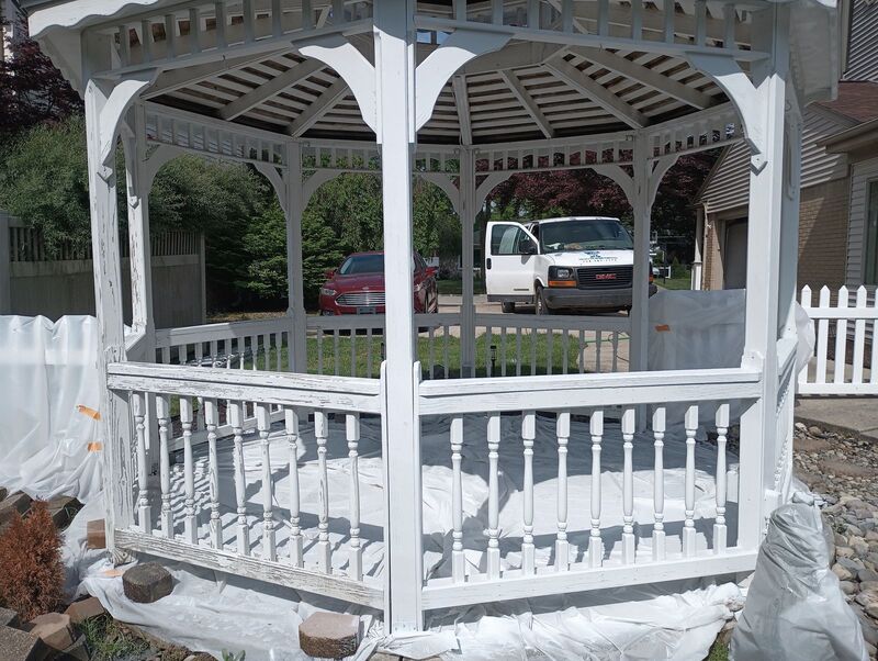 Proscope Home Painting van parked on site during a gazebo repaint, viewed through the gazebo frame