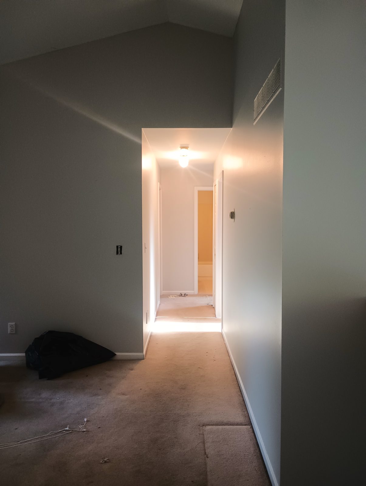 Finished hallway in warm gray with white trim