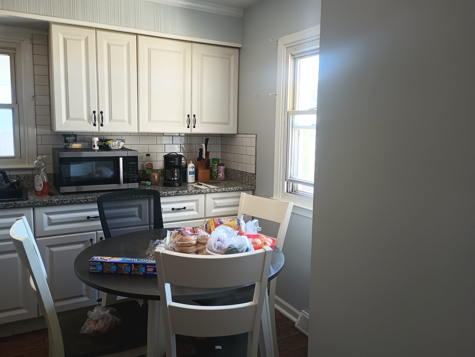 Finished kitchen with light cabinets and dining table