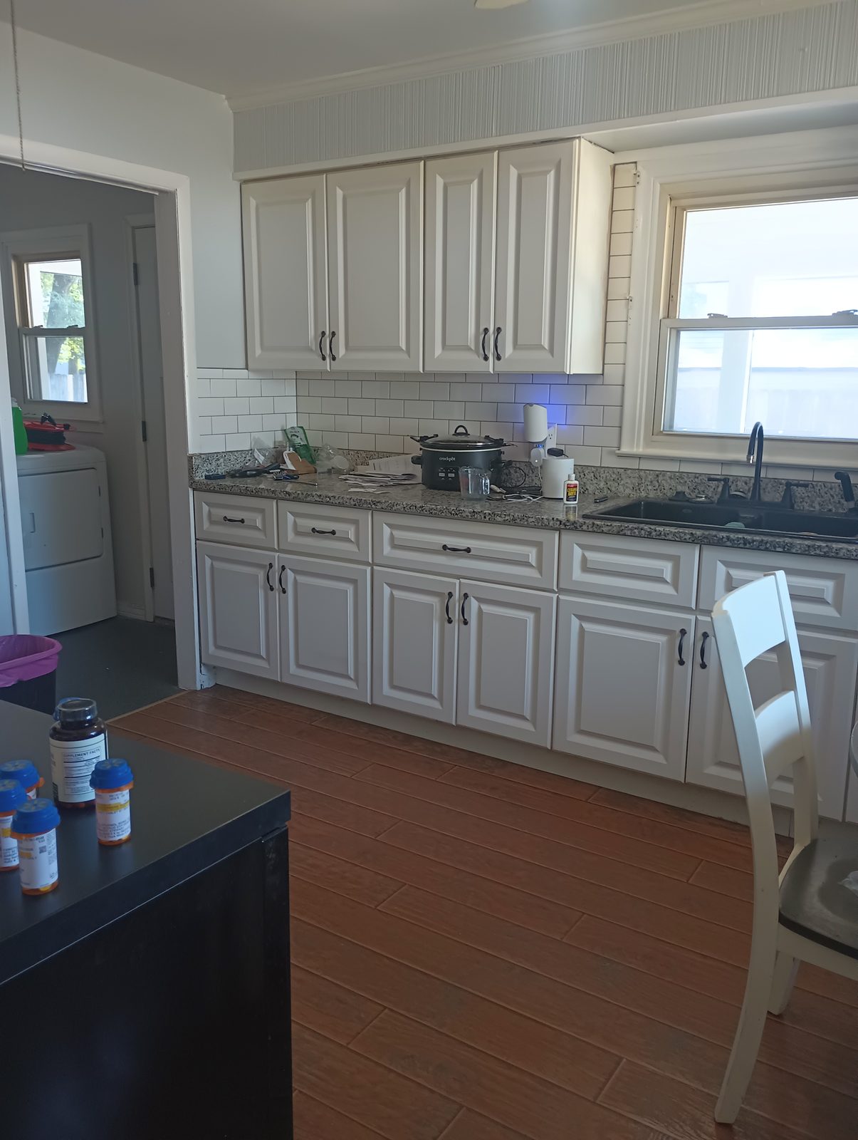 Same kitchen after repaint in light warm gray