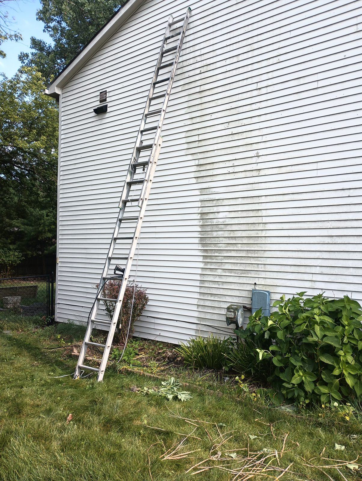 Same siding mid-wash, clean on one side
